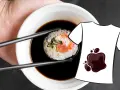 Une main tient une pince à sushi trempant un rouleau dans une sauce soja. Une tache de sauce soja est dessinée sur un t-shirt blanc.