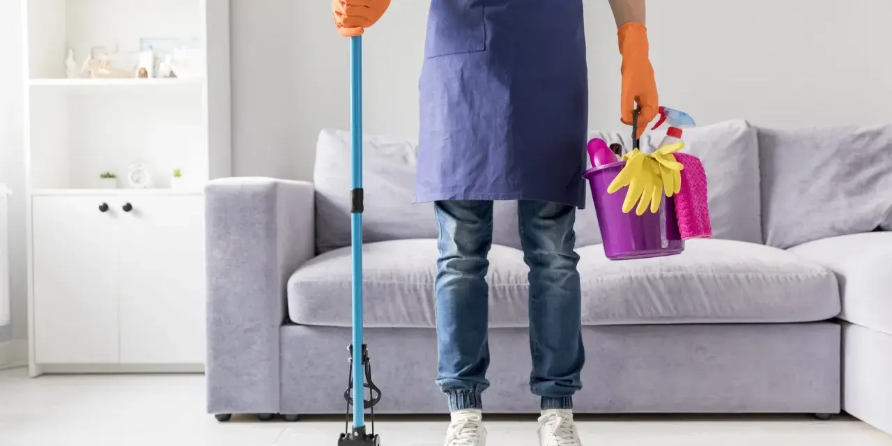 Prêt à laver par terre avec une serpillère et un seau rempli de produits de nettoyage.