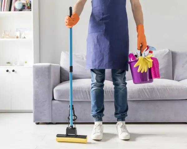 Prêt à laver par terre avec une serpillère et un seau rempli de produits de nettoyage.